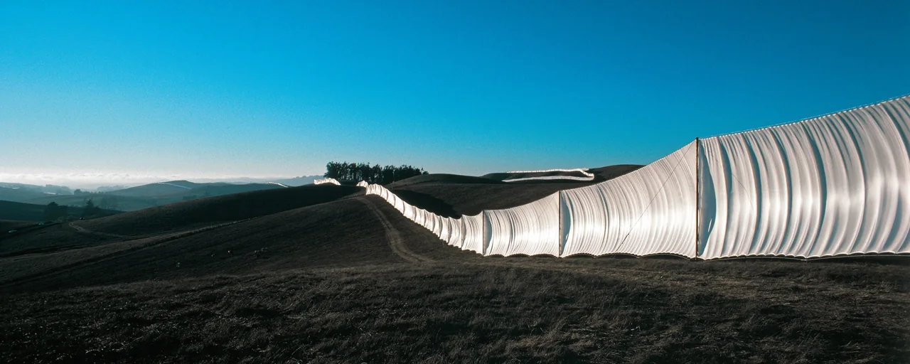 Running Fence follows the rolling California hills in a long ribbon of illuminated white fabric.